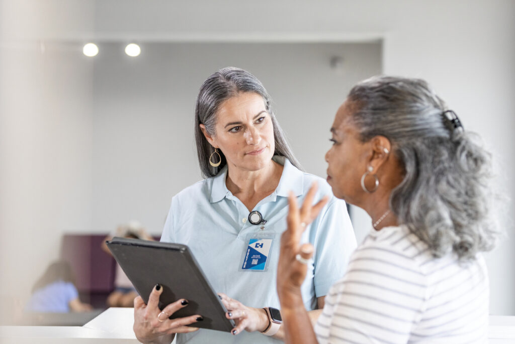 Mature female patient gestures while asking the physical therapist questions