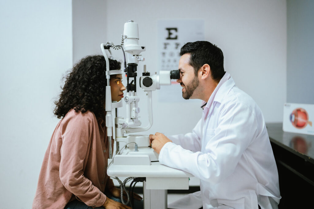 Eye doctor looking at patient's eyes through a scope